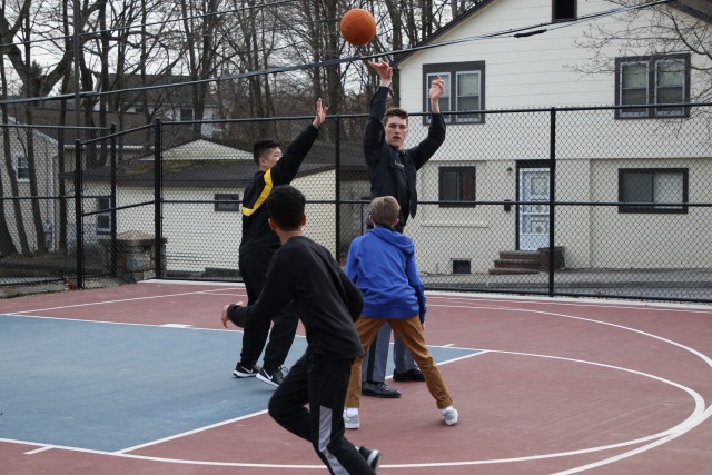 Class of 2022 Cadets Michael Kaffka (passing the basketball) and Mason Lee play basketball with “littles” Sean Larkins and Tyler Nichols during a Big Brothers Big Sisters cadet club session.