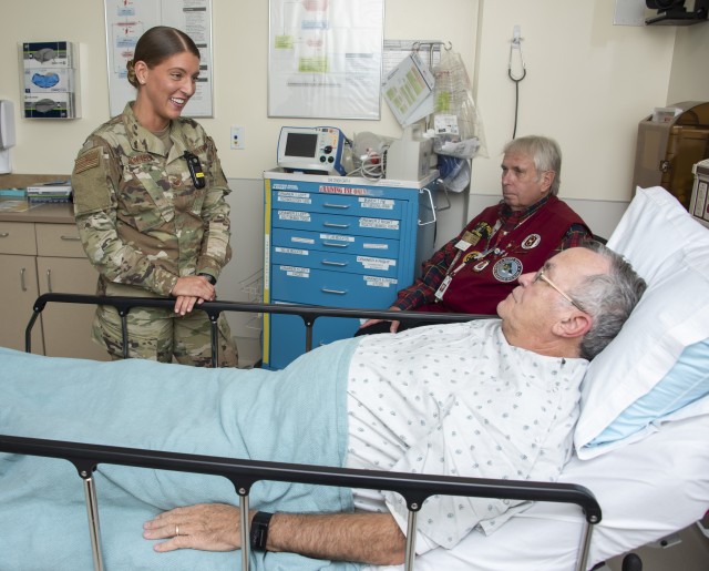 U.S. Air Force Staff Sgt. Summer Johnson, medic, practices using the AIDET (Acknowledge, Introduce, Duration, Explanation and Thank You) model with a simulated patient and family member at Brooke Army Medical Center, Fort Sam Houston, Texas, Dec....