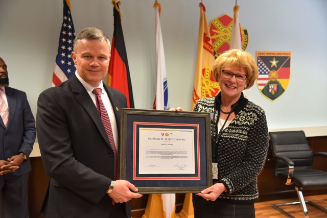 Installation Management Command-Europe Director Tommy Mize presents the 2019 Norman H. Marcus Award to Ingrid Osewalt, U.S. Army Garrison Rheinland-Pfalz Family and Morale, Welfare and Recreation (MWR) program analyst and acting deputy director,...