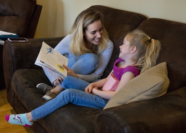 Kristy Schoonmaker helps her daughter, Hailey, improve her reading skills at their home in Carthage, North Carolina, on March 11, 2020. 