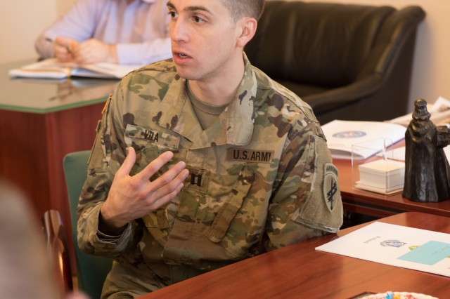 Capt. Tyler Vela, 418th Civil Affairs Battalion, speaks with the local community about the impending DEFENDER- Europe 20 exercise Feb. 20.  418th Civil Affairs Battalion's and 13th Expeditionary Sustainment Command’s community relations teams...