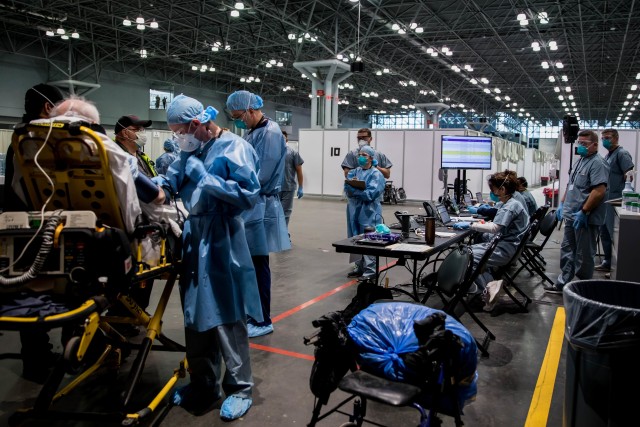 Army Spc. Daniel Fields, assigned to the 9th Hospital Center, takes a patient’s blood pressure reading in the Javits New York Medical Station. Soldiers, along with Department of Health and Human Services personnel and other federal, state and...