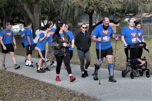 Sgt. First Class Jeff Dawson, pictured with the red, white and blue headband, is joined by friends, family, and members of his chain of command as he walks a 5k in Tampa, Florida, Feb. 15, 2020. This marks an significant milestone for Dawson, an...