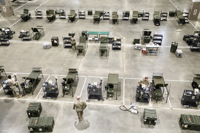 Rows of beds and medical equipment line the floor in the CenturyLink Field Event Center in downtown Seattle, Wash., March 30, 2020. The site is undergoing a major transformation from a sports arena to a world-class Army hospital.