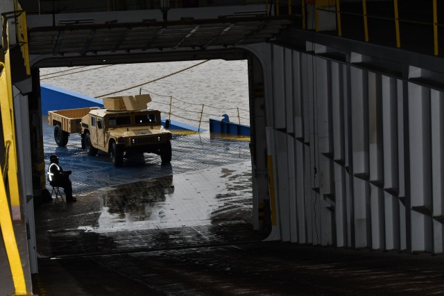 A contract worker waves on a HMMW to the M/V Resolve  February 20, 2020 at the Port Beaumont, Texas in support of DEFENDER-Europe 20. The ship will carry military equipment to the European theater as part of almost 6,000 pieces of cargo that the...