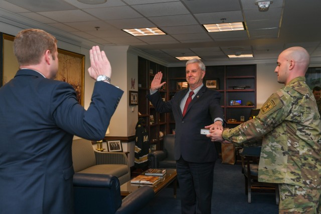 Secretary of the Army Ryan D. McCarthy, left, swears in James E. McPherson as the 34th undersecretary of the Army in Arlington, Va., Mar. 26, 2020.