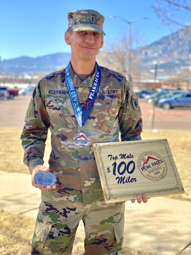 Chief Warrant Officer 3 David S. Kleparek, human resources technician with the 11th Expeditionary Combat Aviation Brigade, poses with the medal, buckle, and plaque he won during the Snow Devil Snowshoe Race: Winter Ultra in the Green Mountains of Vermont, Feb. 29, 2020.  Kleparek placed first in the snowshoe race after completing 100 miles in 36 hours, 54 minutes, and 30 seconds.