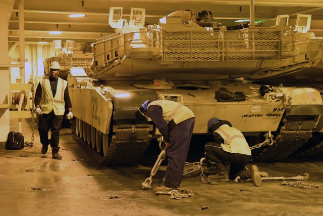 Contract workers secure A1 Abrams tanks inside he Bob Hope-class roll-on/roll-off ship USNS Benavidez February 22, 2020 in support of DEFENDER-Europe 20. This ship will carry military equipment to the European theater as part of almost 6,000...