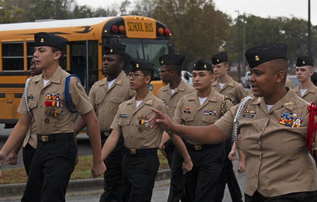 U.S. Navy Junior Reserve Officers’ Training Course cadets from Jenkins High School in Chatham County, Georgia march towards the Hunter Army Airfield Theater for a discussion panel event, March 4, at HAAF in Savannah, Georgia. The...