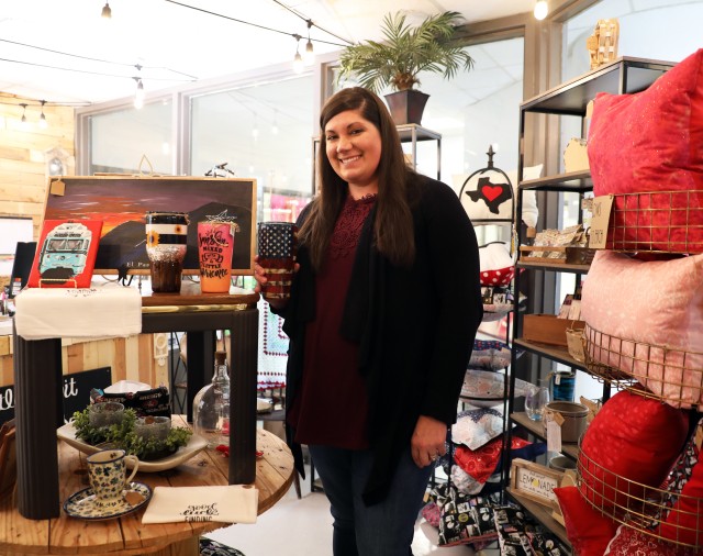 Fort Bliss, Texas - Meagan McCullough, a native of Suwanee, Georgia, spouse of Sgt. 1st Class Andrew McCullough, 2nd Squadron, 13th Cavalry Regiment, 3rd Armored Brigade Combat Team, 1st Armored Division, displays her handcrafted tumblers inside the A Little Bit of Bliss gift shop on Feb. 6. The shop has become a haven for military spouses looking for a creative outlet, hobby, comradery or employment. Aside from independent opportunities like A Little Bit of Bliss, the Army is taking an active approach to help military spouses find jobs, build careers and improve their quality of life. (U.S. Army photo by Jean S. Han)