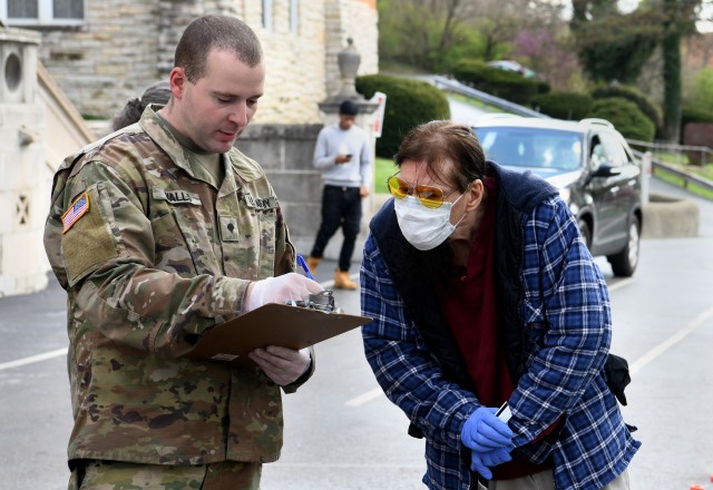 Ohio National Guard Spc. Darrell Walls reviews a shopping list with Donn Smith, a local resident, while supporting Operation Steady Resolve’s humanitarian relief mission with the Freestore Food Bank’s Healthy Harvest Mobile Market in Cincinnati, Ohio April 2, 2020.