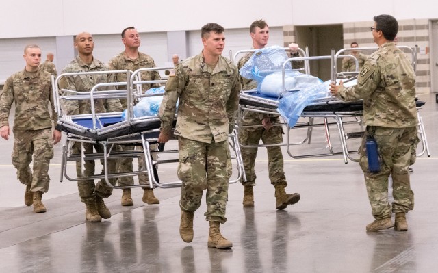 Texas Army National Guard troops set up a field hospital in response to COVID-19 April 1, 2020, at the Kay Bailey Hutchison Convention Center in Dallas, Texas. 