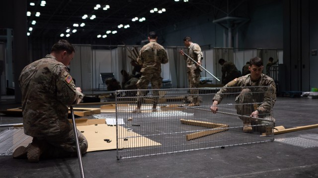 Soldiers assigned to the 531st Hospital Center build shelving at the Jacob K. Javits Convention Center in Manhattan. Soldiers from the 531st along with the 9th Hospital Center and other federal, state and local agencies are building a temporary...