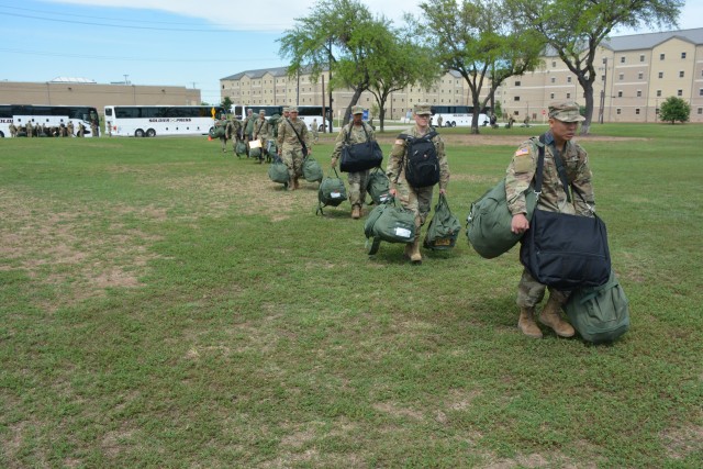 68W Combat Medic arriving from Fort Sill, OK to begin their advanced individual training at Fort Sam Houston, TX move in formation while maintaining proper social distancing after departing from their travel bus.