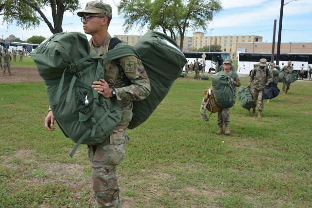 68W Combat Medic arriving from Fort Sill, OK to begin their advanced individual training at Fort Sam Houston, TX move in formation while maintaining proper social distancing after departing from their travel bus.