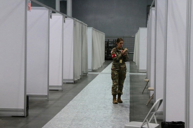 A U.S. Army Soldier from the 9th Hospital Center based out of Fort Hood, Texas and 531st Hospital Center out of Fort Campbell, Kentucky works to stock medical supplies for the temporary medical station located at Jacob K. Javits Convention Center...