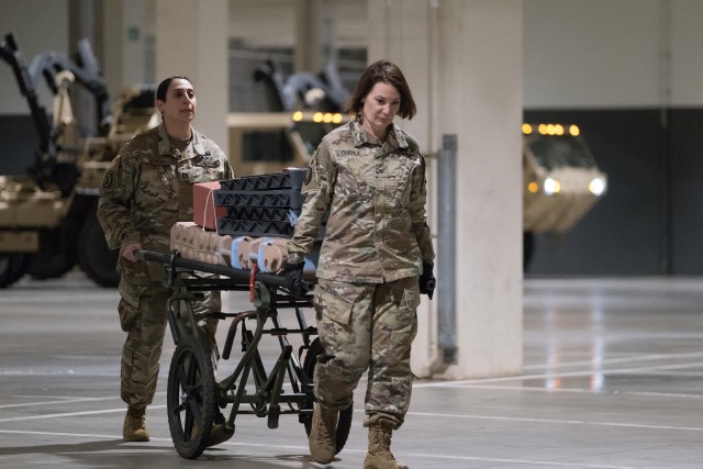 Seattle, Wash., March 30, 2020 – Soldiers transport supplies from a shipping container to their location in the hospital. Soldiers from the 627th Army Hospital based in Fort Carson, Colo., worked to set up a field hospital in the Centurylink...