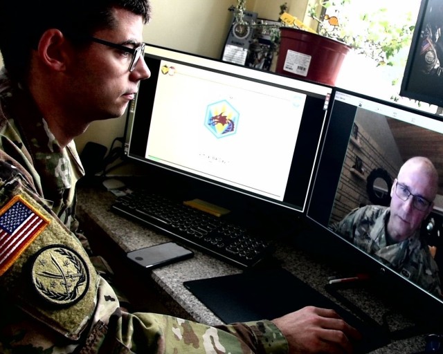 Capt. Marcel Bedard (left) of the 325th Expeditionary Military Intelligence Battalion participates in a discussion during the 336th Expeditionary Military Intelligence Brigade’s virtual battle assembly from Watertown, MA, March 21, 2020. (US Army photo by Capt. Marcel Bedard)