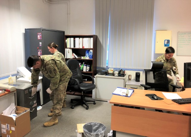 Soldiers from 10th Army Air and Missile Defense Command, and members of the U.S. Army Garrison Rheinland-Pfalz Team Clean, clean a workspace in Kaiserslautern, Germany. Team Clean consists of troops pulled from units across the garrison assigned...