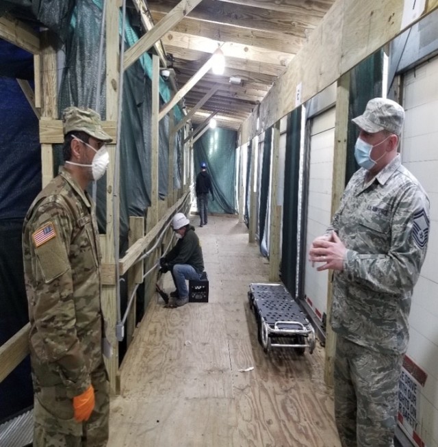 Maj. Raziel Amar, New York National Guard chaplain, talks to a service member at the Javits Center.