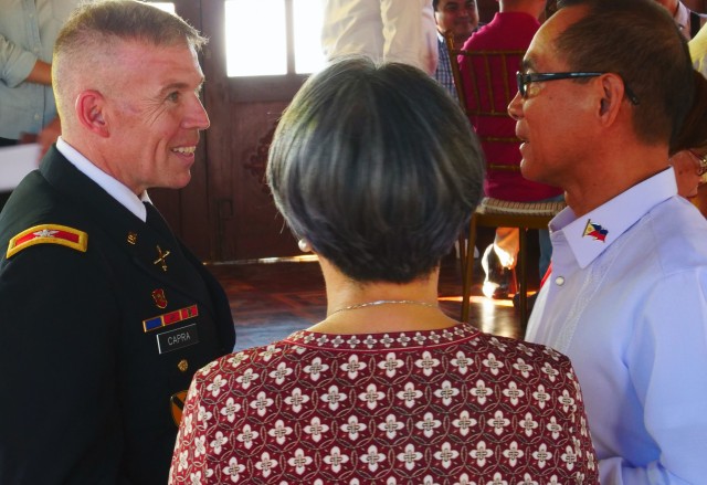 BAGAC, BATAAN, Philippines--Col. Kevin Capra, commander of 3rd Armored Brigade Combat Team, 1st Cavalry Division, speaks to Philippines Undersecretary for Civil Veterans and Retiree Affairs Reynaldo Mapagu (right), here, Feb. 12 before the unveiling of a statue honoring those who fought in the Battle of Bataan. Members of the Greywolf brigade were in the Philippines to represent the 1st Cavalry Division--the first American Division into occupied Manila--during Battle of Manila 75th Anniversary remembrance events Feb 11-15.