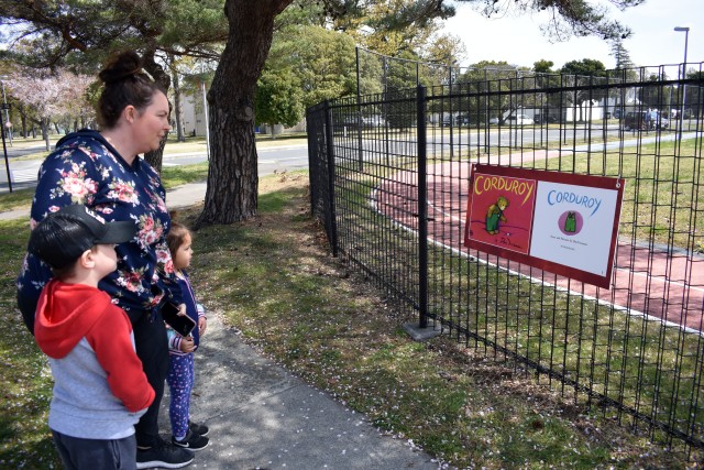 Danielle Carmona and her children Camden, 6, and Kaia, 4, start the Story Walk along the fence next to John O. Arnn Elementary School on Sagamihara Family Housing Area, Japan, April 7, 2020. The book installation is part of a Camp Zama library initiative that aims to give parents and children fun, safe and constructive activities during COVID-19 restrictions.