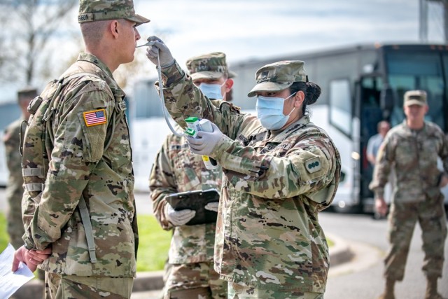 A new recruit gets his temperature taken at Fort Sill, Okla., April 7, 2020. The Army has begun to halt recruit movement to basic training for at least two weeks. The brief pause will allow the Army to boost its testing capability at initial-entry...