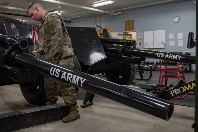 A Soldier assigned to the Presidential Salute Battery, 1st Battalion, 3d U.S. Infantry Regiment (The Old Guard) cleans a 3-inch anti-tank guns of World War II vintage, mounted on a 105mm Howitzer on Joint Base Myer-Henderson Hall, Virginia, March 25, 2020. PSB maintains their guns at all times to ensure mission readiness.