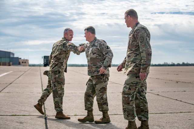 Gen. Paul E. Funk II, middle, the commander of the U.S. Army Training and Doctrine Command met with Col. Anthony Lugo, left, Fires Center Chief of Staff, at the Henry Post Army Airfield at Fort Sill, OK, greeting him with an elbow bumps on April 7, 2020 to limit physical contact. Funk visited Fort Sill to meet with leadership throughout Fort Sill and assess the measures in place to prevent the spread of COVID-19. (U.S. Army photo by Sgt. Dustin D. Biven / 75th Field Artillery Brigade)