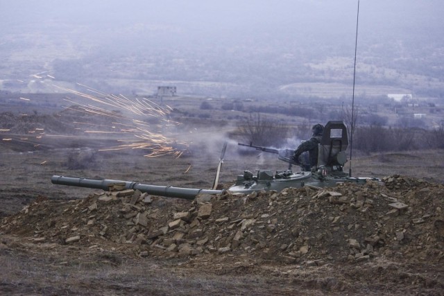 Bulgaria's Lt. Stilian Slavchev, shoots a machine gun mounted to the top of his T-72 tank during U.S. Army's C Company, 1st Battalion, 5th Cavalry Regiment, 2nd Armored Brigade Combat Team, 1st Cavalry Division's Combined Arms Live Fire Exercise...