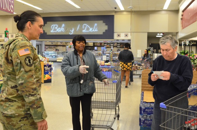 Command Sgt. Maj. Rebecca Myers, Fort Stewart Garrison’s senior enlisted leader, speaks with a Fort Stewart Commissary employee and customer on Fort Stewart, Georgia., April 3, 2020. Myers visits several places on the installation every day to ensure operations are running smooth and to get an update on how people in the Marne community are doing. (U.S. Army photo by Sgt. Zoe Garbarino)