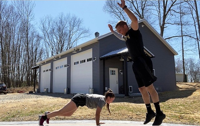 Class of 2021 Cadet Lane Peters, an Army West Point wrestler, and his sister, Class of 2023 Cadet Sage Peters, an Army West Point softball player, challenge each other during a first to 100 burpees competition at their home in Uhrichsville, Ohio. All cadets have to challenge themselves in different ways as COVID-19 has limited their ability to access gyms across the country. (Photo courtesy of Class of 2021 Cadet Lane Peters)