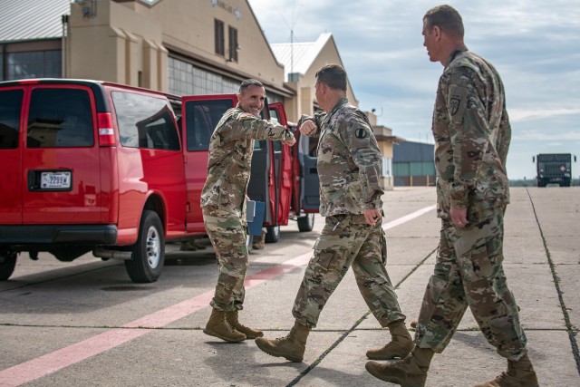 Gen. Paul E. Funk II, middle, the commander of the U.S. Army Training and Doctrine Command met with Col. David R. Zinnante, left, commander of Reynolds Army Health Clinic, at the Henry Post Army Airfield at Fort Sill, OK, greeting him with an elbow bumps on April 7, 2020 to limit physical contact. Funk visited Fort Sill to meet with leadership throughout Fort Sill and assess the measures in place to prevent the spread of COVID-19. (U.S. Army photo by Sgt. Dustin D. Biven / 75th Field Artillery Brigade)