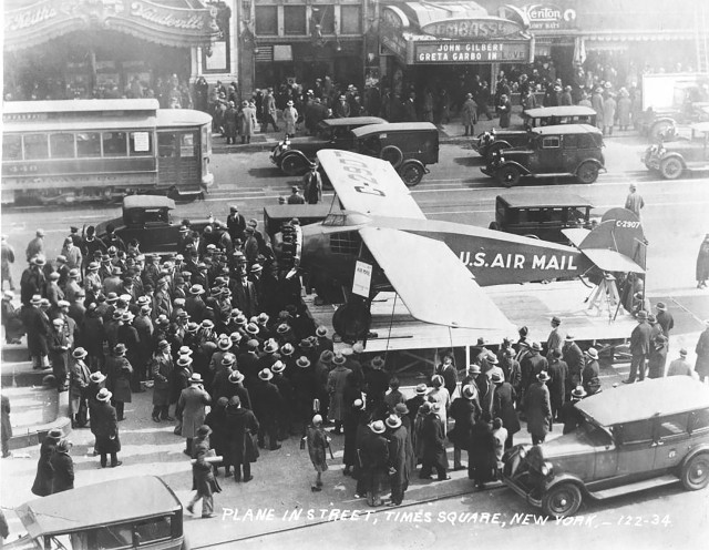 People look at an Air Mail Plane on display in Times Square, New York City, Jan. 1, 1927. (Photo courtesy of U.S. National Archives)