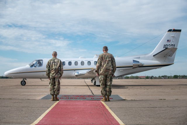 Fort Sill’s Commanding General Ken L. Kamper and Command Sgt. Maj. John W. Foley, wait at the Henry Post Army Airfield at Fort Sill, OK, for the arrival of Gen. Paul E. Funk II, the commander of the U.S. Army Training and Doctrine Command on April 7, 2020. Funk visited Fort Sill to meet with leadership throughout Fort Sill and assess the measures in place to prevent the spread of COVID-19. (U.S. Army photo by Sgt. Dustin D. Biven / 75th Field Artillery Brigade)