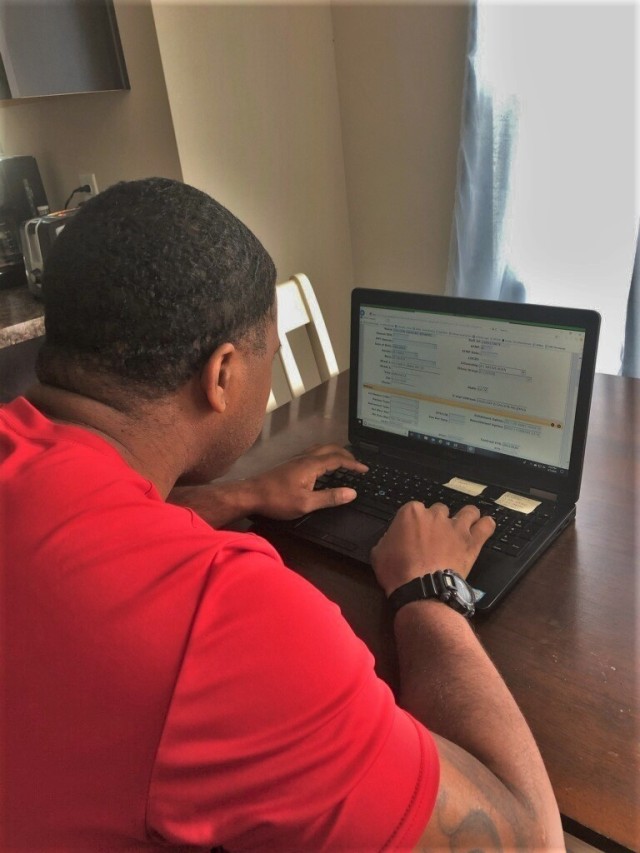 U.S. Army Staff Sgt. Vincent Dillard, the Division Artillery Brigade career counselor with 3rd Infantry Division, works on a reenlistment contract from his home in Ludowici, Georgia, April 7, 2020. Soldiers and Deptartment of the Army Civilians at Fort Stewart and at Hunter Army Airfield in Savannah, Georgia, have been meeting reduced manning requirements by teleworking from home during the ongoing COVID-19 pandemic response and spread mitigation directives. (Courtesy Photo)