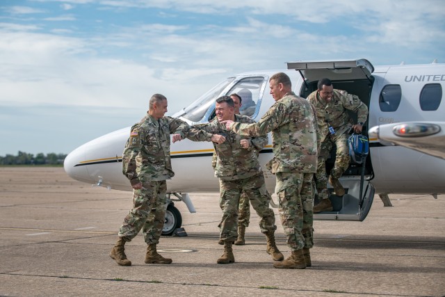 Fort Sill’s Commanding General Ken L. Kamper and Command Sgt. Maj. John W. Foley, greet Gen. Paul E. Funk II, the commander of the U.S. Army Training and Doctrine Command at the Henry Post Army Airfield at Fort Sill, OK, with elbow bumps on...