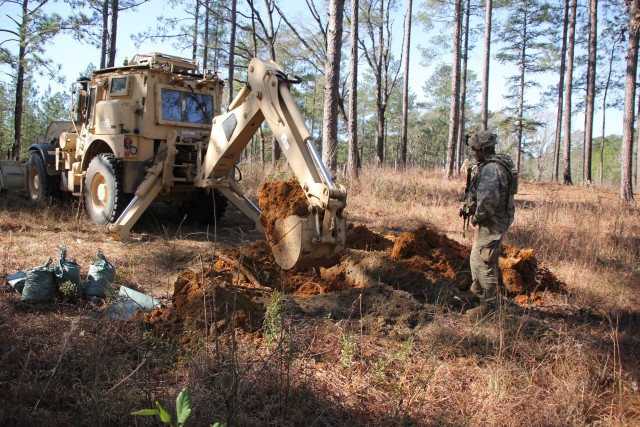 Photo Caption: Soldiers from the 861st Engineer Support Company, Rhode Island National guard, participate in TF Spartan as part of a Rotation Augmentation Support package, Jan. 9-29, 2020, at the Joint Readiness Training Center on Fort Polk, La. Over several days, they provided a variety of force protection measures in support of friendly forces, which included constructing berms for artillery and anti-tank ditches and route clearance missions. (Photo courtesy of U.S. Army)