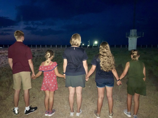 Stacey Morgan and her children watch her husband and their father, NASA astronaut U.S. Army Col. Andrew Morgan, lift off on the Soyuz MS-13 rocket from the launch pad at the Baikonur Cosmodrome, Kazakhstan, July 20, 2019. Morgan, commander of the U.S. Army Space and Missile Defense Command’s Army astronaut detachment, will serve aboard the International Space Station for nine months as a part of Expeditions 60, 61 and 62.  