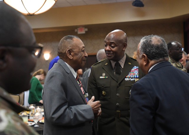 Robert Young, an Army veteran and nephew of Sgt. Issac Woodard, talks with U.S. Army Training Center Commander Brig. Gen. Milford “Beags” Beagle Jr., after the African American and Black History Month Observance Feb. 21 at the NCO Club.