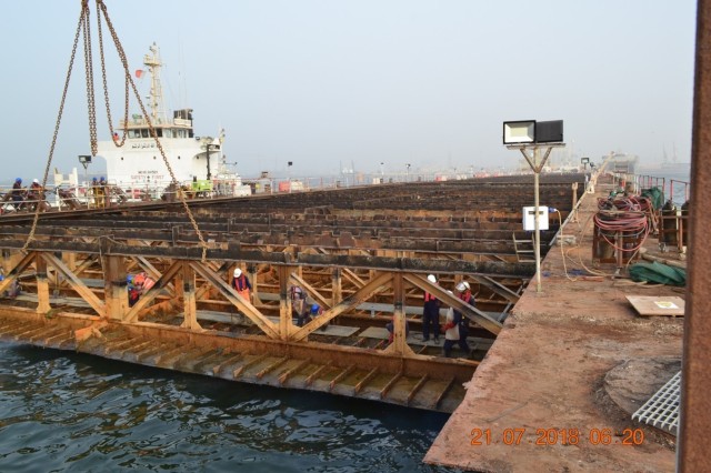 The old naval pier at Naval Support Activity Bahrain during the demolition phase of a U.S. Army Corps of Engineers Middle East District project to construct a new steel and concrete pier.