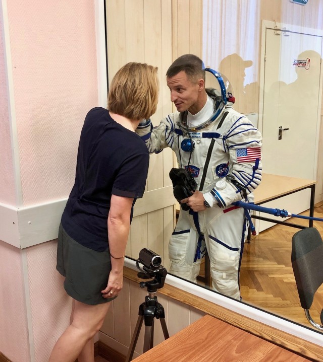 Quarantined and wearing his Russian Sokol suit just hours before his launch to the International Space Station, NASA astronaut U.S. Army Col. Andrew Morgan and his wife, Stacey, exchange a last private moment through the glass at the Baikonur Cosmodrome, Kazakhstan, July 20, 2019. Assigned to International Space Station’s Expeditions 60, 61 and 62,  Morgan, will be separated from his family for nine months until his scheduled return in April 2020. 