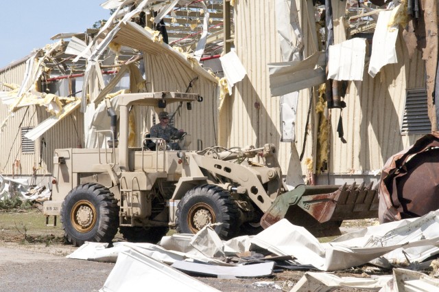 A Soldier with the 307th Engineer Battalion, moves debris with a bulldozer on Fort Bragg Monday, April 18 as part of the Directorate of Public Works&#39; effort to clean up areas hit by a tornado, which struck Fayetteville and the southern edge of Fort Bragg Saturday, April 16. 