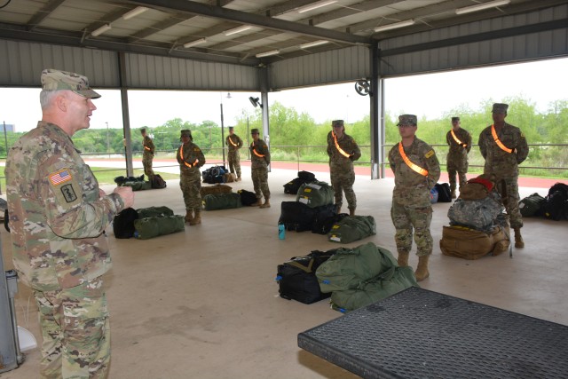 Maj. Gen. Dennis P. LeMaster, Commanding General U.S. Army Medical Center of Excellence, addresses 68W Combat Medic Soldiers as they prepare to depart Fort Sam Houston, TX. The Soldiers were transported in controlled air and ground movements to their next duty of assignment as an exception to the Department of Defense stop movement enacted to stop the potential spread of the 2019 Coronavirus Disease, or COVID-19.