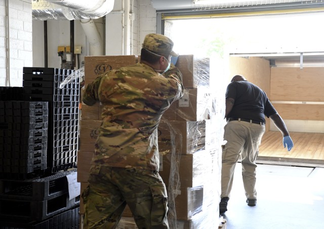 Sgt. 1st Class Michael Soles, Fort Jackson’s G5 non-commissioned officer in charge, and Supply Specialist Mark Hall load a pallet of travel kits April
6. The kits were donated to Fort Jackson trainees and activated South Carolina National Guards units by the South Carolina USO. “We are paying it
forward to the men and women that need it most,” said Joanie Thresher, executive director of the South Carolina USO.