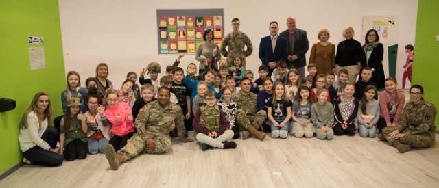 Secondary school students pose with Soldiers after speaking with them about the life of a Soldier March 10 during a two-day community outreach tour.  On Day two, Soldiers spoke with over 50 secondary school students on their jobs, gave insight on who they are in and out of uniform and answered questions from those in attendance. (U.S. Army photos by Sgt. 1st Class Kelvin Ringold)