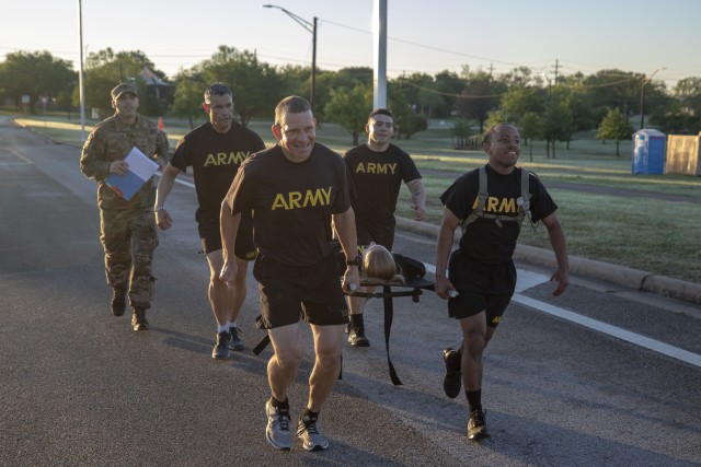 Former Command Sgt. Maj. Michael Grinston, U.S. Army Forces Command, helps carry a tactical litter during physical training at Sadowski Field A, on Fort Hood, Texas. Grinston now serves as Sgt. Maj. of the Army. (Photo by Sgt. Ryan Rayno)