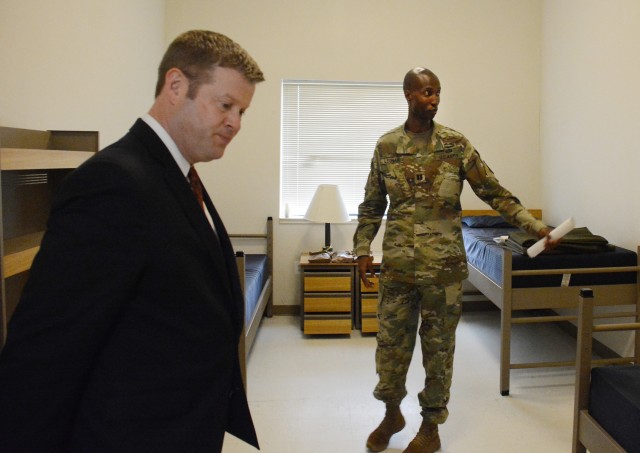 Capt. Maurice Leonard, commander of Uniform Company, 262nd Quartermaster Battalion, shows Secretary of the Army Ryan D. McCarthy one of the rooms on a floor of the barracks that will be used as a quarantine area if COVID-19 gets a foothold within the military ranks here. McCarthy was accompanied by Sgt. Maj. of the Army Michael A Grinston. The senior leaders spent several hours at the installation, also receiving updates on the capabilities of a mortuary affairs unit and what steps Kenner Army Health Clinic has taken to stop the spread of the virus.
