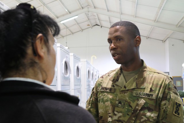 U.S. Army Staff Sgt. Thomas Browne, a native of Liberia, Africa, who became an American citizen, serves as the billeting NCO for Taji Military Complex, Iraq. As a child, Browne survived a civil war and life in refugee camps before emigrating to the United States. He became both a civilian police officer and joined the military. Browne is shown conducting an inspection of Taji laundry facilities Feb. 8, 2020. His reserve unit promoted him soon afterward. Combined Joint Task Force – Operation Inherent Resolve remains unified and determined in its mission to degrade and defeat Daesh and continues to work with allies and partners to implement stabilization efforts. (U.S. Army photo by Sgt. 1st Class Gary A. Witte)