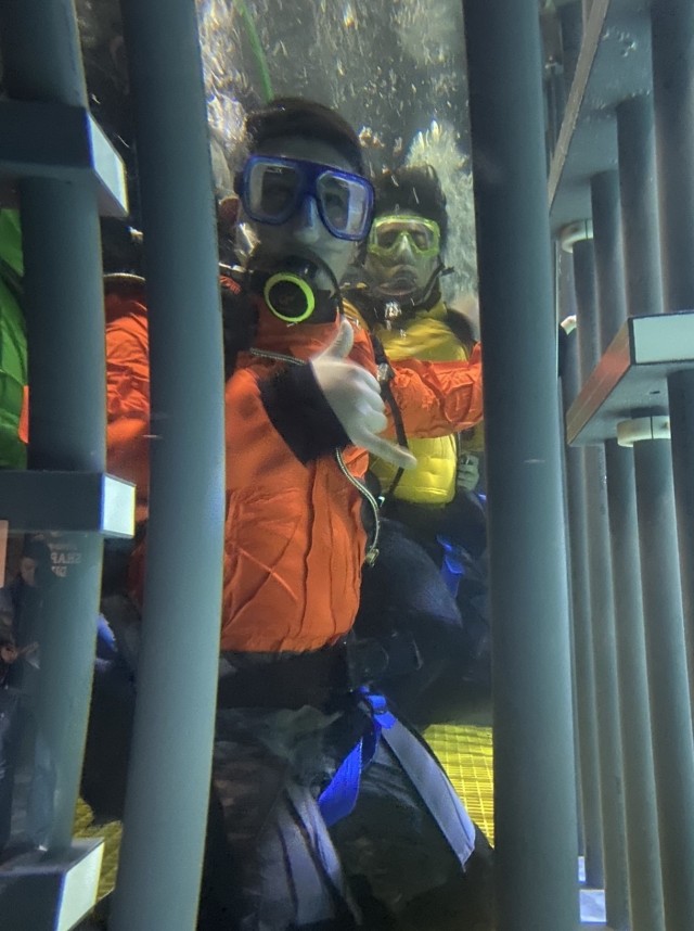 Sgt. Samuel Haro acknowledges the camera from the shark diving cage at the Point Defiance Zoo and Aquarium in Tacoma, Washington.